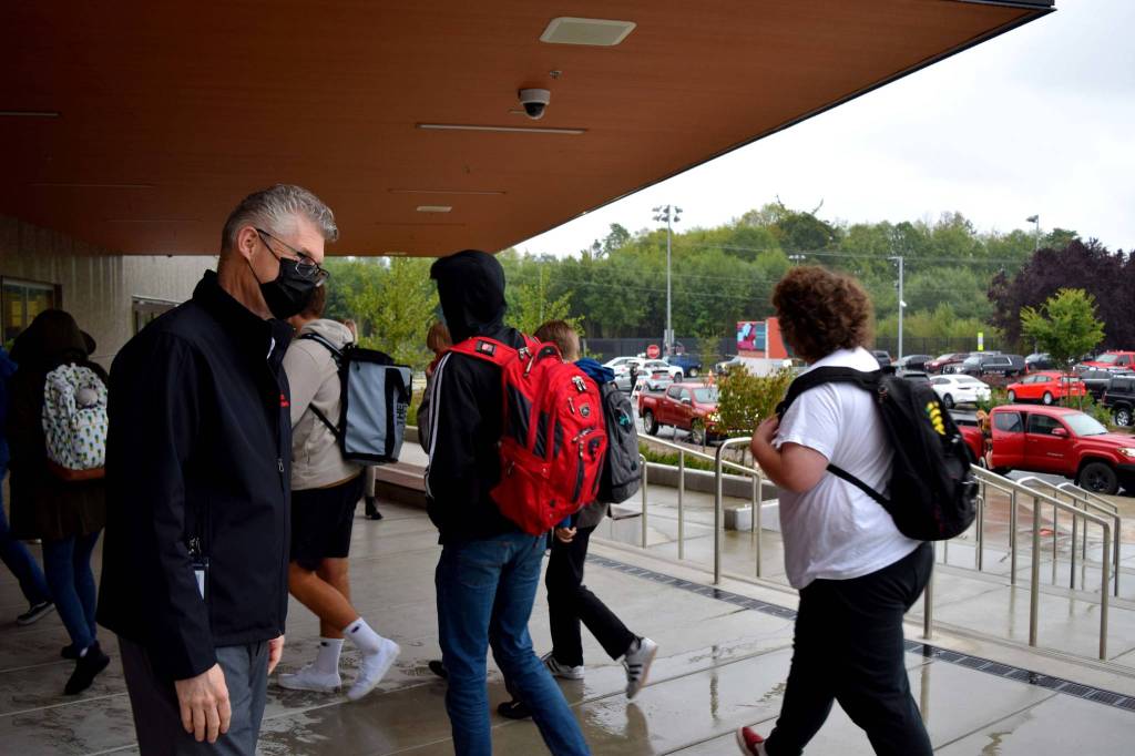 Snoqualmie Valley School District Superintendent Lance Gibbon (left) welcomes Mount Si High School students on their first day of school, Aug. 31. Photo Conor Wilson/Valley Record.