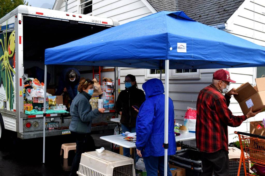 Snoqualmie Valley Pet Food Bank volunteers provide free pet food to owners out of a U-Haul on Oct. 6. Photo by Conor Wilson/Valley Record