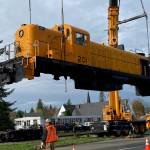 Workers lift Locomotive 201 to move it from Snoqualmie to the Nevada Northern Railway Foundation. Photo William Shaw/Valley Record.