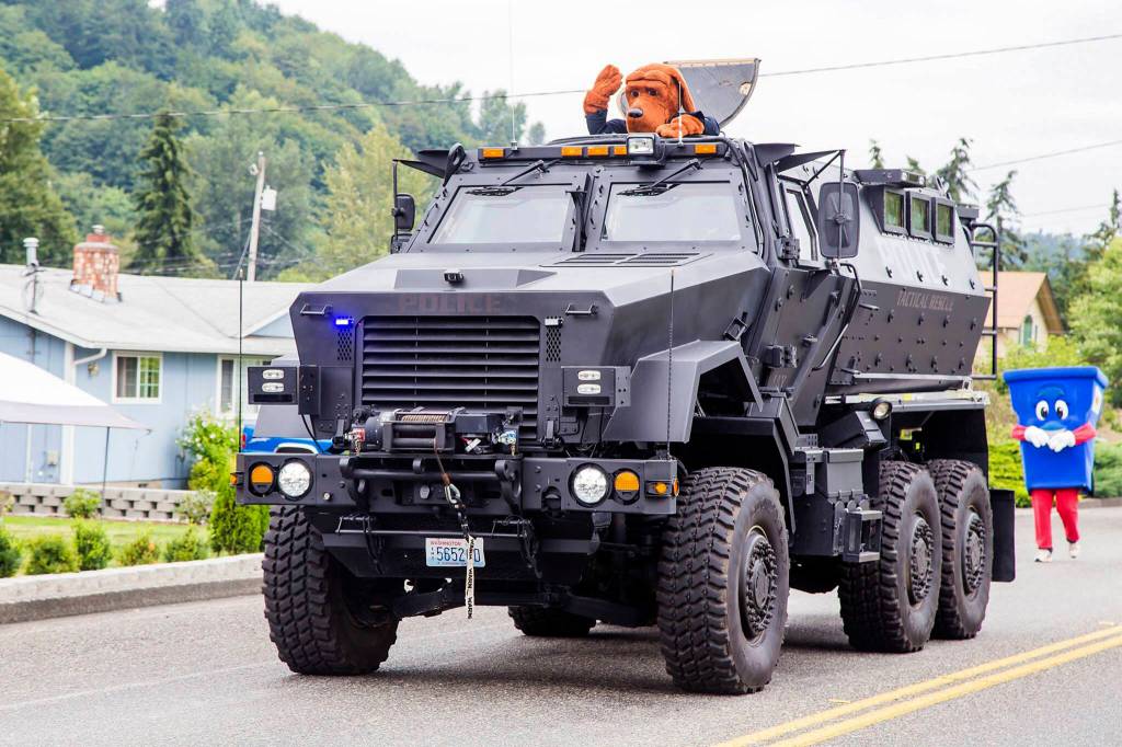 Snoqualmie Police Department houses a surplus military mine-resistant armored personnel carrier. It is seen here during a 2016 parade in Algona. Courtesy photo.