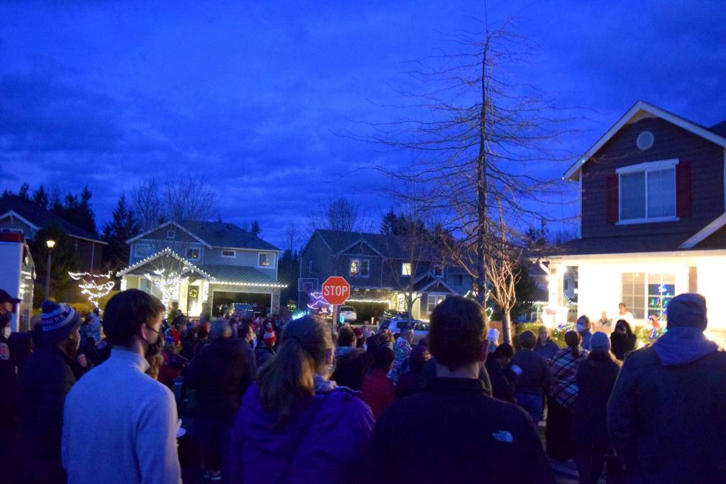 Christmas carolers, led by Valley Center Stage, sing to Zander Wainhouse and his family outside their house in Snoqualmie on Nov. 29. Zander was diagnosed with brain cancer in Dec. 2020. Photo Conor Wilson/Valley Record