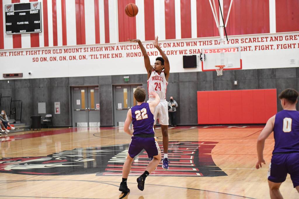Senior Cam Holliway shots a three-pointer. Photo courtesy of Calder Productions.