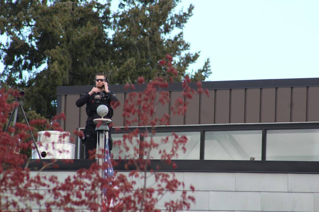 A law enforcement officer scans the crowd outside the Mel Lindbloom Student Union building. Photo by Alex Bruell/Sound Publishing