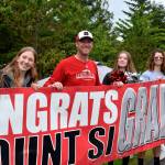 Valley residents hold up a sign during the Mount Si High School Senior Car Parade on June 4. Photo by Conor Wilson/ Valley Record