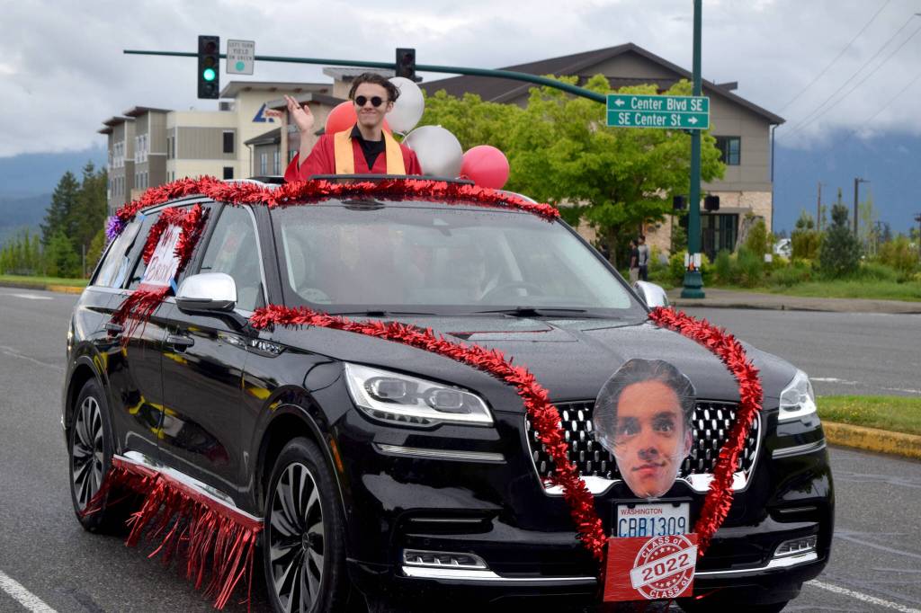 A Mount Si High School senior waves to parade watchers during during the Senior Car Parade on Saturday, June 4. The class of 2022 will hold its graduation Friday, June 10 at the ShoWare Center in Kent. Photo Conor Wilson/Valley Record.