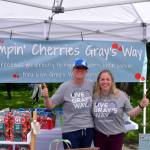 Summer Stumpf (l) founder of nonprofit, Live Grays Way, poses in her booth.