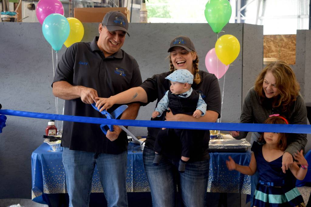 Gary King (left), owner of Kings Quality Auto, and his fiancée, Stefanie Price, celebrate the opening of their new space at 1208 Bendigo Boulevard North in North Bend on June 11. Photo by Conor Wilson/Valley Record