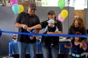 Gary King (left), owner of Kings Quality Auto, and his fiancée, Stefanie Price, celebrate the opening of their new space at 1208 Bendigo Boulevard North in North Bend on June 11. Photo by Conor Wilson/Valley Record