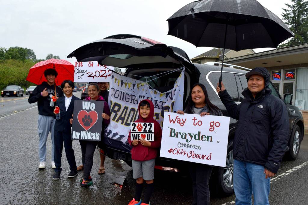Spectators pose for a photo at the Fall City Graduate Parade. Photo Conor Wilson/Valley Record.