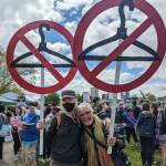 Two people stand with coathanger signs at the reproductive rights protest on May 14, 2022 at Cal Anderson Park. Hannah Saunders/Sound Publishing