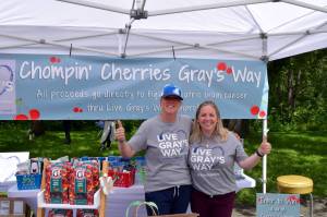 Summer Stumpf (l) founder of nonprofit, Live Grays Way, poses in her booth at Fall City Days. File photo by Conor Wilson/Valley Record