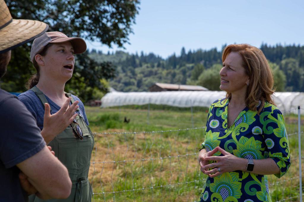 Photo courtesy of U.S. House Agriculture Committee
U.S. Rep. Kim Schrier, D-Sammamish, (right) speaks with Local Roots vegetable Farm owners Siri Erickson-Brown and her husband Jason Salvo on their property in Duvall.