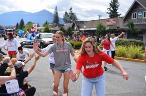 Members of Mount Si High Schools basketball team high-five parade spectators during the Festival at Mt Si. All photos Conor Wilson/Valley Record.