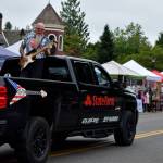 A man plays guitar in the back of a Jeff Warren State Farm Insurance truck during the Snoqualmie Days festival. Photo Conor Wilson/Valley Record.