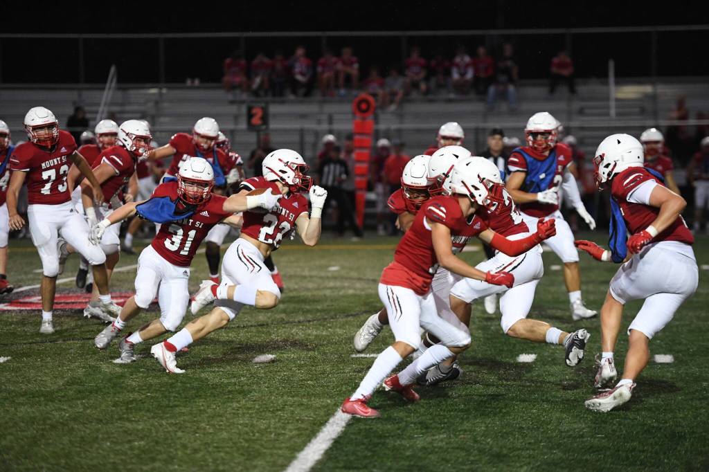 Photo Courtesy of Calder Productions 
Junior Running Back Beau Phillips (22) breaks a tackle in Mount Sis Scarlet and Gray game on Aug. 26.
