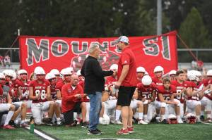 Longtime head coach Charlie Kinnune (left) shakes hands with new head coach Steve Botulinski. Kinnune retired after last season, having coached the Wildcats since 1992. Photo Courtesy of Calder Productions.