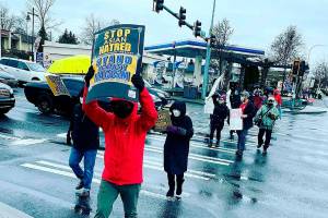 Supporters hold signs at a Stop Asian Hate rally in Federal Way in March 2021. File photo