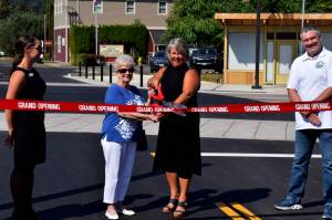Carnation Mayor Kim Lisk (center right) and Connie Carter celebrate the near end of construction along Tolt Avenue on Aug. 31. Photo by Conor Wilson/Valley Record