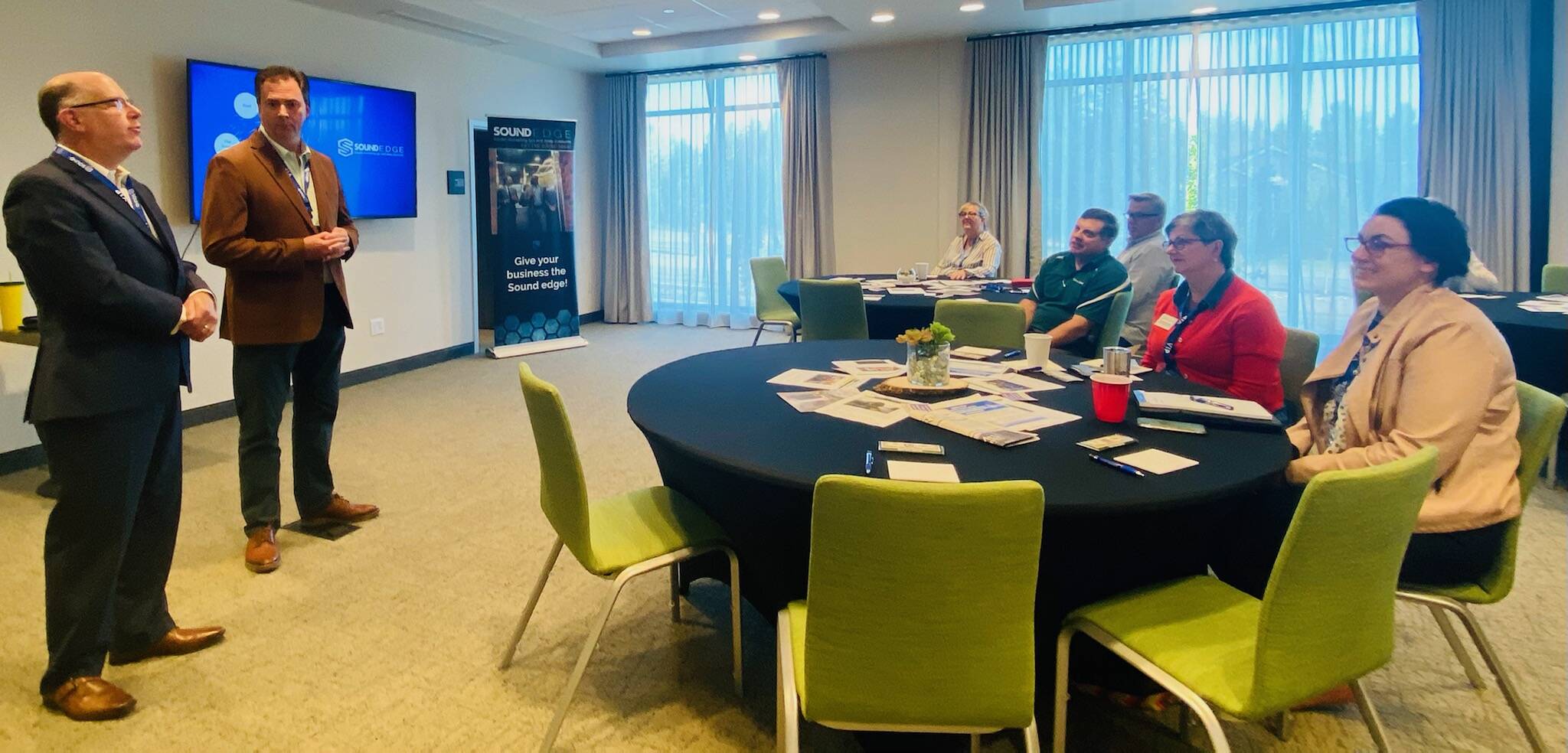 Courtesy Photo 
Valley Record General Manager William Shaw and Sound Publishing Vice President and Everett Daily Herald Publisher Rudi Alcott (left) speak to business owners at an advertising seminar on Aug. 23.