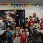 Carla Netus second grade class at North Bend Elementary pose for a photo with Clark and Karrie Roberts of Ultimate Vision. Photo by Conor Wilson/Valley Record