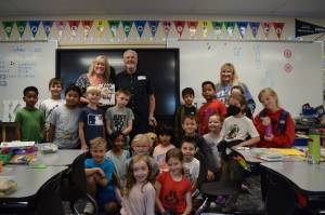 Carla Netus second grade class at North Bend Elementary pose for a photo with Clark and Karrie Roberts of Ultimate Vision. Photo by Conor Wilson/Valley Record