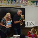Clark (right) and Karrie Roberts read their book A Guide Dog named Arby to students at North Bend Elementary. Photo by Conor Wilson/Valley Record