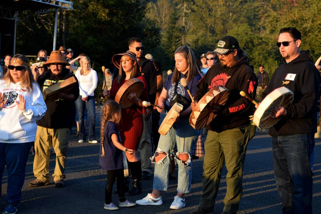 Snoqualmie Tribal members play a song as the boat departs to release the Kokanee at Lake Sammamish State Park. Photo by Conor Wilson/Valley Record