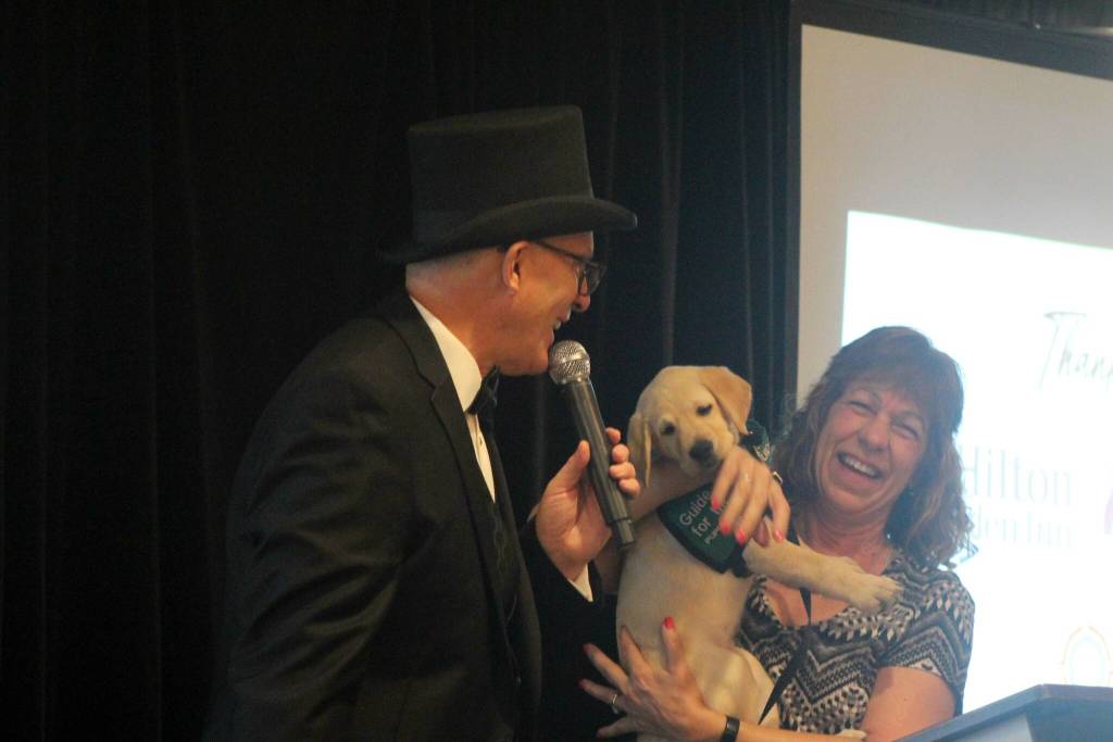 Larry Snyder, left, looks at Clark Roberts new guide dog-in-training. Photo by Conor Wilson/Valley Record
