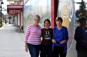 Jules Hughes, center, stands with Jackie Norris (l) and Kris Kirby outside Miller's in Carnation. Photo by Conor Wilson/Valley Record