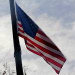 The American flag waves in the breeze as its raised by members of the Snoqualmie Tribes Honor Guard.