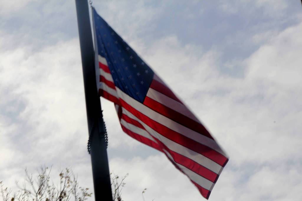 The American flag waves in the breeze as its raised by members of the Snoqualmie Tribes Honor Guard.
