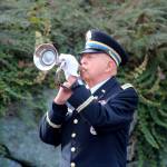 Art Farash, an Army Veteran and American Legion Post 79 member, plays TAPS during a flag ceremony.