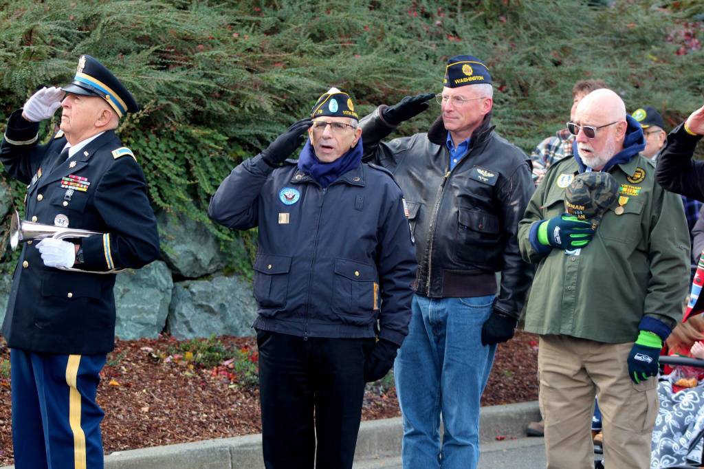 Veterans salute the flag at the Snoqualmie Casino  on Nov. 11 during a singing of the national anthem. All photos Conor Wilson/Valley Record.