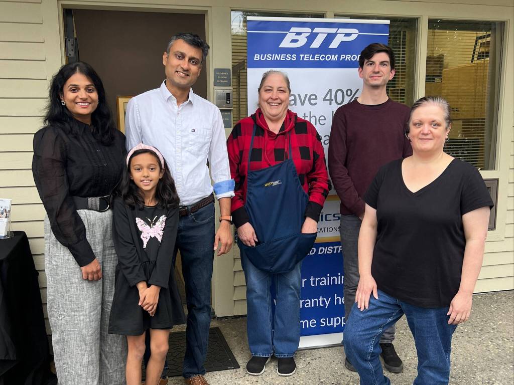 Esha Vimawala and Jimi Shah (left) stand with their employees during a celebration of their Partner of the Year award. Photo courtesy of the SnoValley Chamber of Commerce.