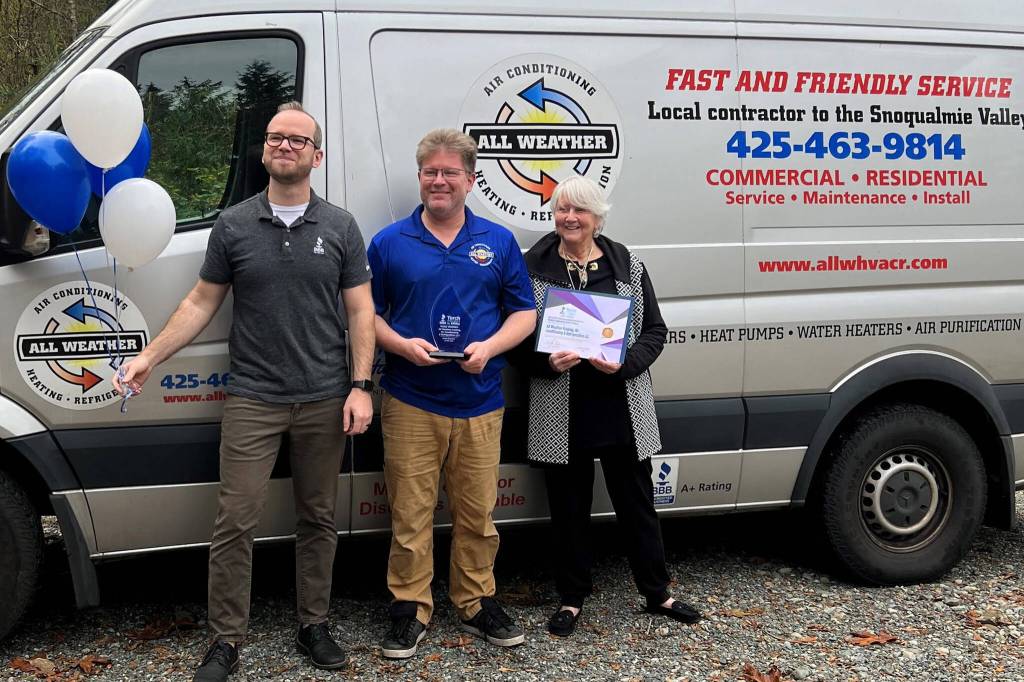 Scott Leibowitz (middle) receives an award from the Better Business Bureau. Photo Courtesy of the SnoValley Chamber.