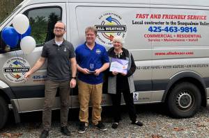 Scott Leibowitz (middle) receives an award from the Better Business Bureau. Photo Courtesy of the SnoValley Chamber.