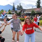 Members of the Mount Si High School basketball team high-five spectators during the Festival at Mount Si Parade in August. The festival was one of several this year to return in-person for the first time since the pandemic. File photo