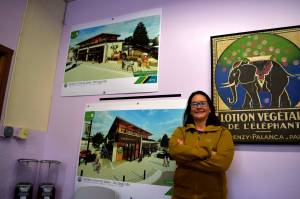 Ana Cortez, Carnations city manager, poses in front of designs for the new city hall building being built at the old library site. Photo by Conor Wilson/Valley Record