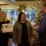 Carousel owner Joelle Gibson (middle) and store manager Cathy Gregory talk with Brian Davis.
