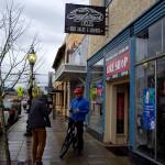 Brian Davis films outside of Singletrack Cycles in downtown North Bend on Nov. 22. Photo by Conor Wilson/Valley Record