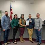 Courtesy Photo.
Empower Youth Networks Executive Director Laura Smith and Program Director Jerry Blackburn pose for a photo with the Carnation City Council. Carnation, alongside the cites of Snoqualmie, North Bend, Duvall, the Snoqualmie Tribe and Snoqualmie and Riverview School Districts, recognized January as Mentoring Month in the Snoqualmie Valley. From left: Ryan Burrell, Dusting Green, Adair Hawkins, Smith, Blackburn, Mayor Jim Ribail, Tim Harris.