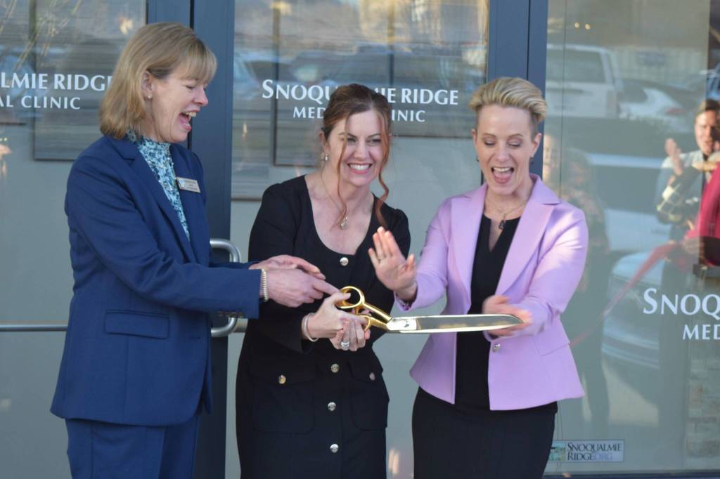 Hospital CEO Renee Jensen (middle), stands with Snoqualmie Mayor Katherine Ross (left) and Dr. Tammy Moore, during a ribbon cutting ceremony outside the Snoqualmie Ridge Medical Clinic on Feb. 8. Photo Conor Wilson/Valley Record.