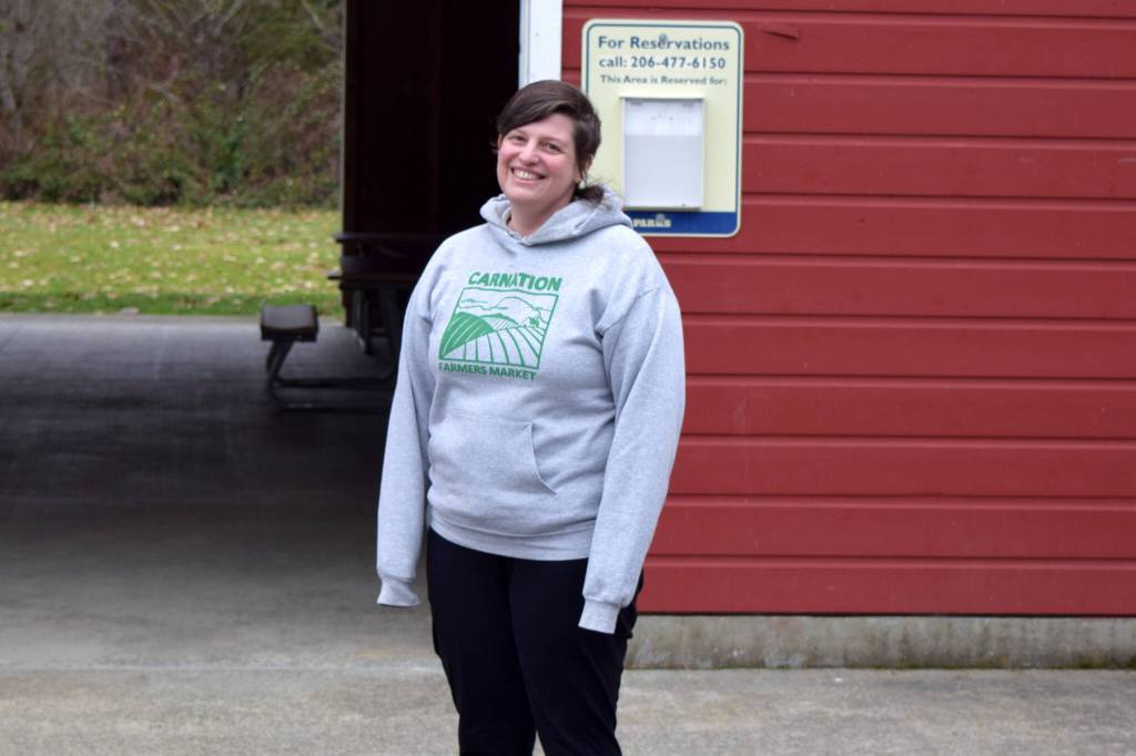 Conor Wilson / Valley Record 
Lindsay Gilliam, executive director of the Carnation Farmers Market, poses in front of the Red Barn at King Countys Tolt-McDonald Park, the markets new home.