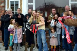 Katie Black (left) and Brittany Mains (center), owners of IGNITE Dance Carnation, hug during their ribbon cutting ceremony on March 4. Photo by Conor Wilson/Valley Record