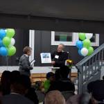 Habitat for Humanity board member Jonathan Pearlstein, right, presents an award to Mimi Krsak, of the Krsak family.