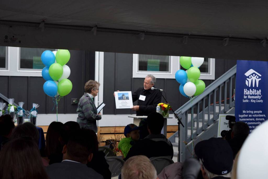 Habitat for Humanity board member Jonathan Pearlstein, right, presents an award to Mimi Krsak, of the Krsak family.