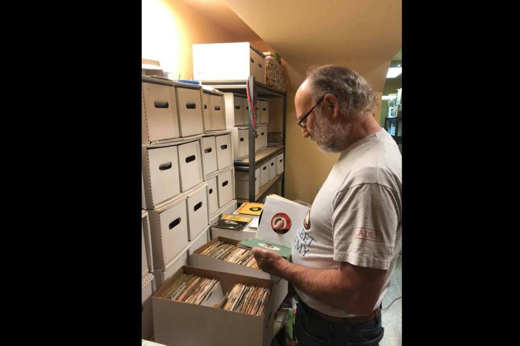 Terry Spring, host of Saturday Night Oldies on Valley 104.9, looks through CDs. Courtesy photo.