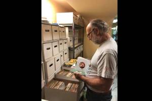 Terry Spring, host of Saturday Night Oldies on Valley 104.9, looks through CDs. Courtesy photo.