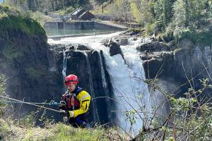 A firefighter starts to rappel to the Snoqualmie River near Snoqualmie Falls as part of a river rescue training session. Courtesy photo, Puget Sound Fire.