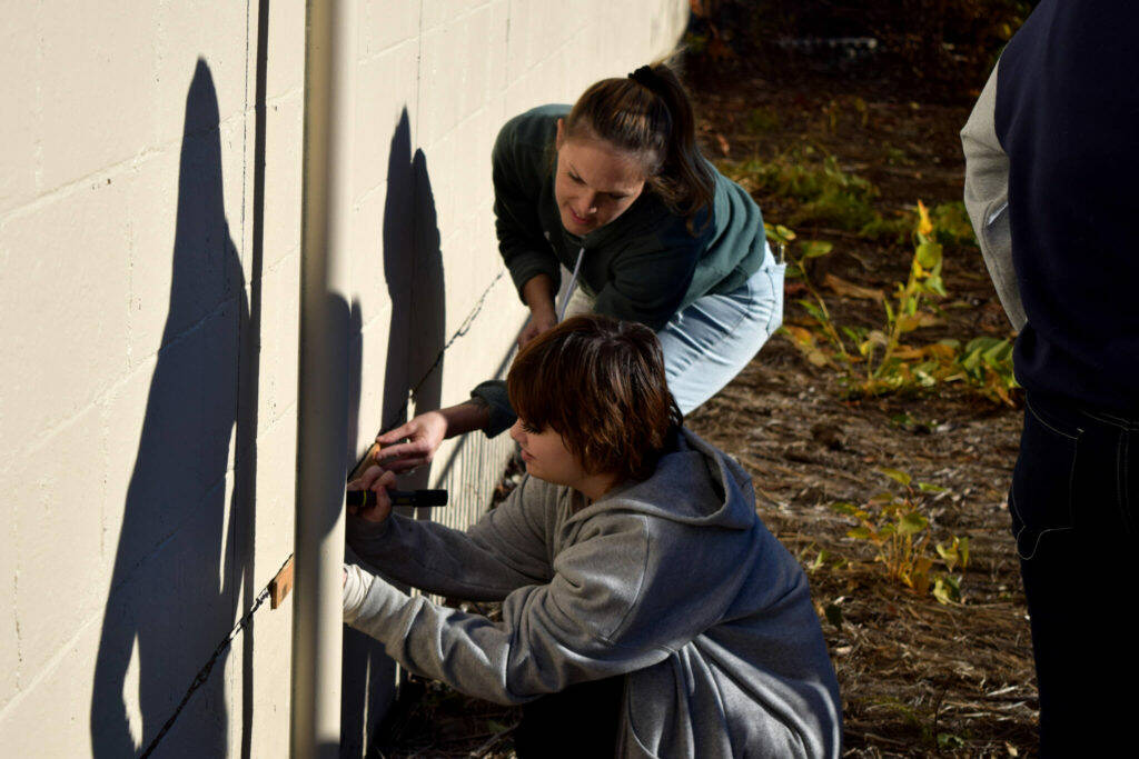 A Two Rivers student works on the mural on Nov. 9, 2022. File photo Conor Wilson/Valley Record.